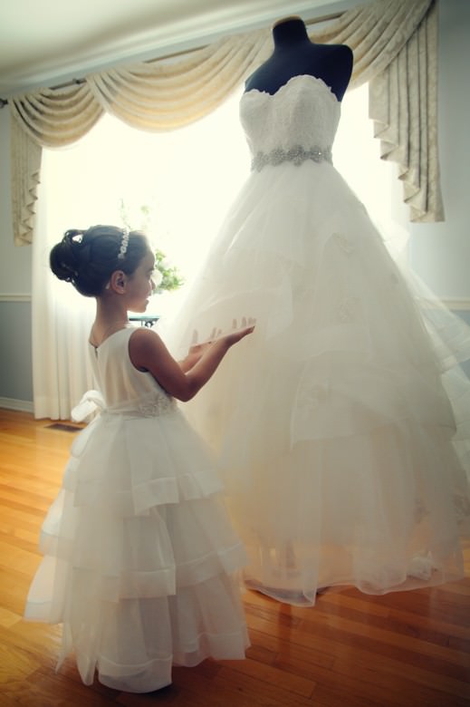 little girls looks at the wedding dress award winning wedding photo by la V image Montreal wedding photographer