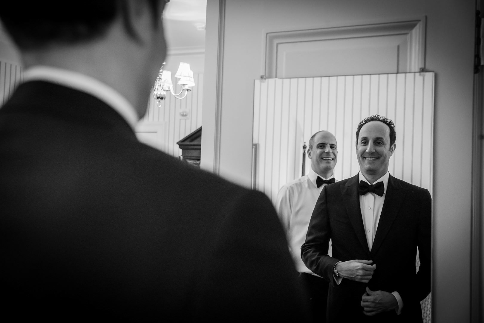 new york city wedding photography photographer photo groom getting ready looking mirror reflection